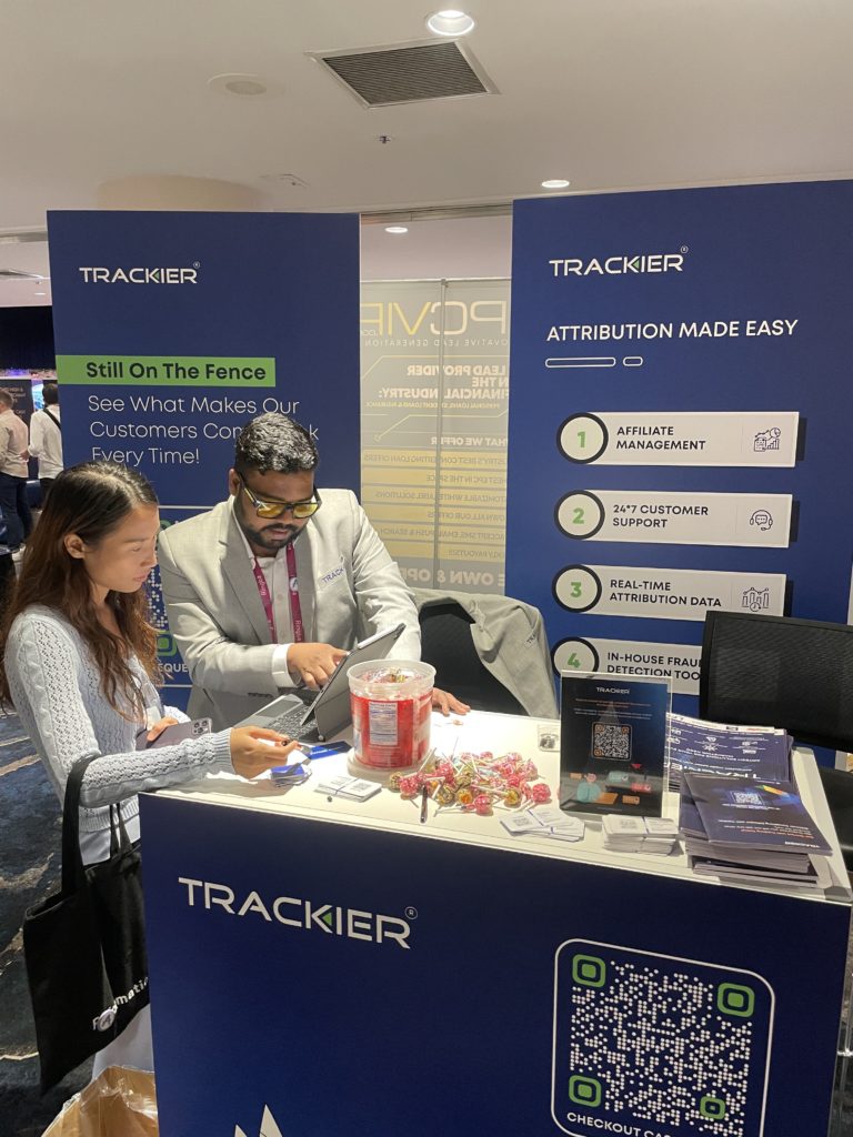 Trackier Founder & CEO Faizan Ayubi attending to a booth visitor at Affiliate Summit East 2023